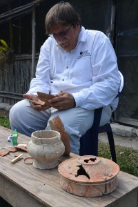 Arlen gluing pottery vessels together